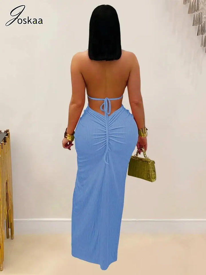 Woman wearing a blue strapless dress with a plain background