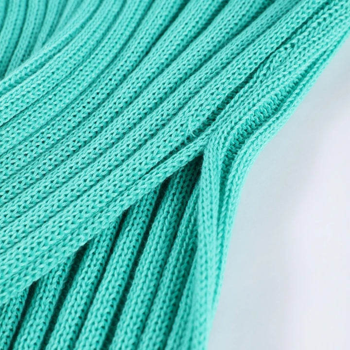 Close-up of teal shoelaces on a light background