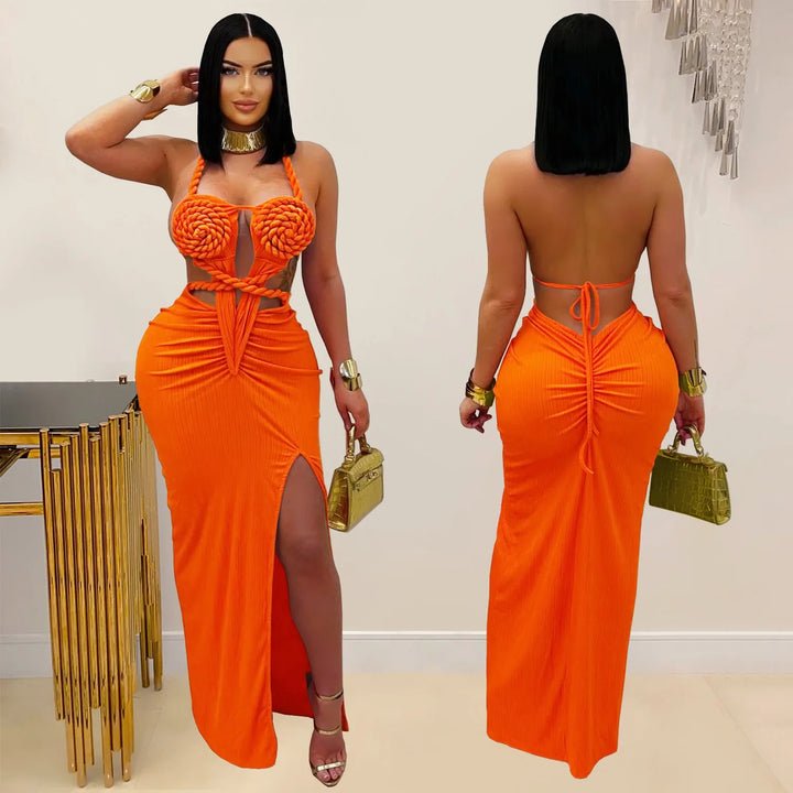 Woman wearing an orange dress with a gold handbag, posing against a neutral background.