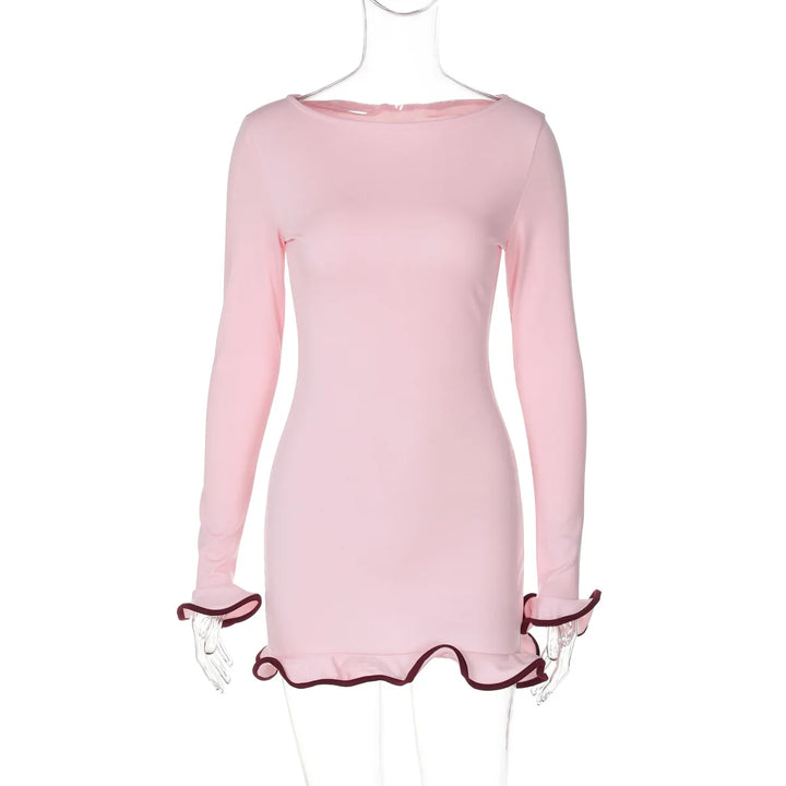 Pink dress with ruffled cuffs on a mannequin against a white background