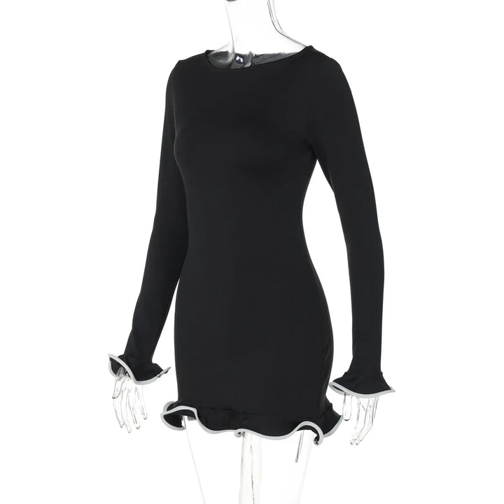 Black dress with ruffled cuffs on a mannequin against a white background