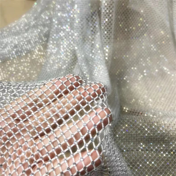 Close-up of silver sequin fabric with a textured pattern