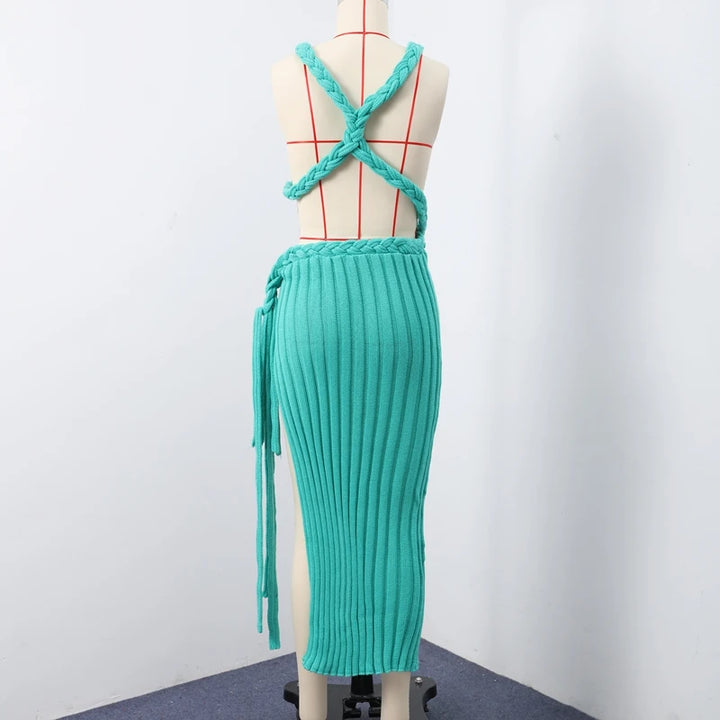 Teal ribbed dress on a mannequin against a white background