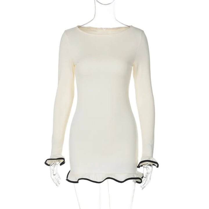 White dress with black trim on a mannequin against a white background