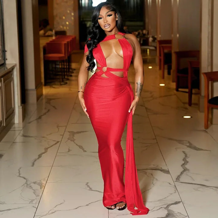 Woman in a red dress standing in a marble hallway