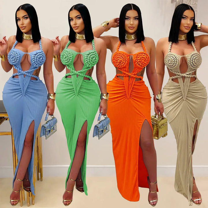 Four women wearing colorful, intricately designed dresses with matching handbags.