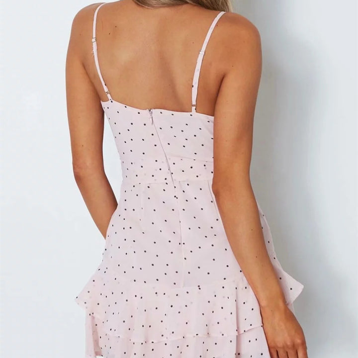 Flowy chiffon dress with ruffle trim and white polka dots on black base